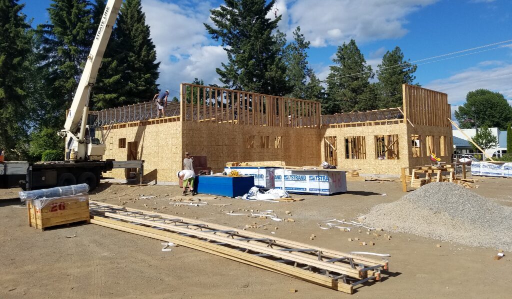 New construction job site development in the framing stage with crane getting ready to set trusses at the new FUKI Steak House restaurant Hayden Idaho