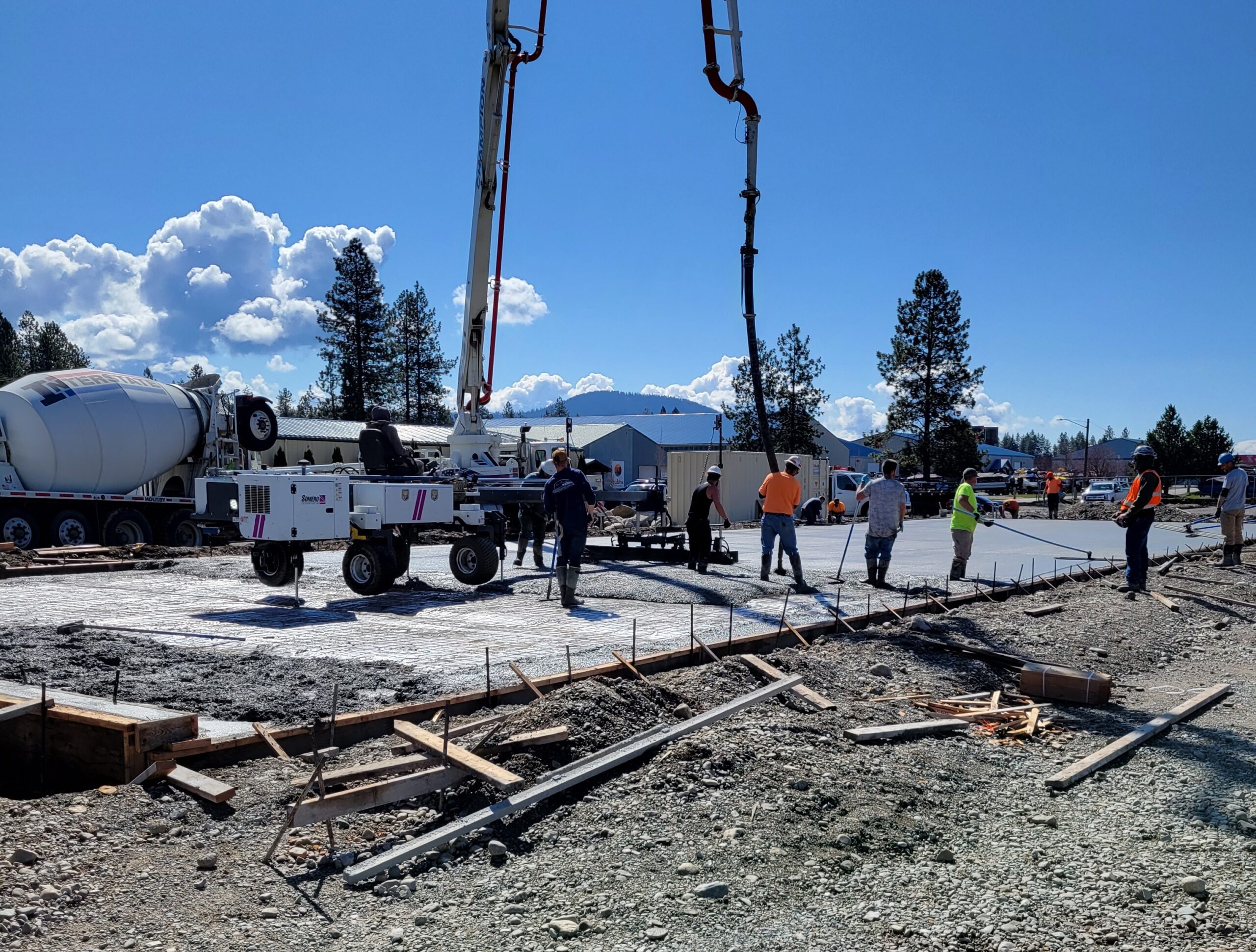 Concrete crew pouring a 5600 square foot slab for a storage unit complex using a state of the art concrete leveling screed in Hayden ID