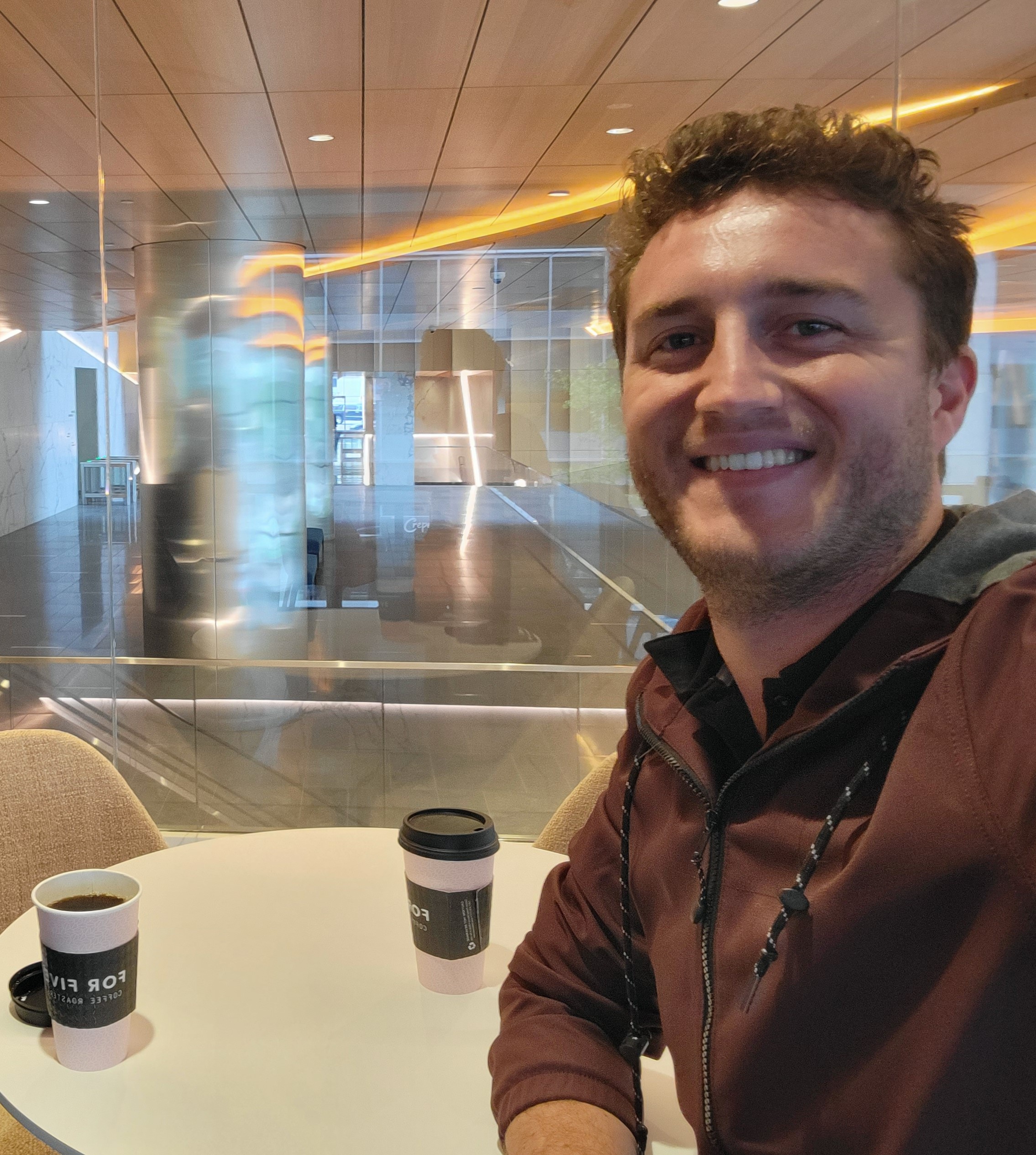 Business and planning advisor Nicholas Johnson enjoying a cup of coffee in a business complex foyer Washington DC