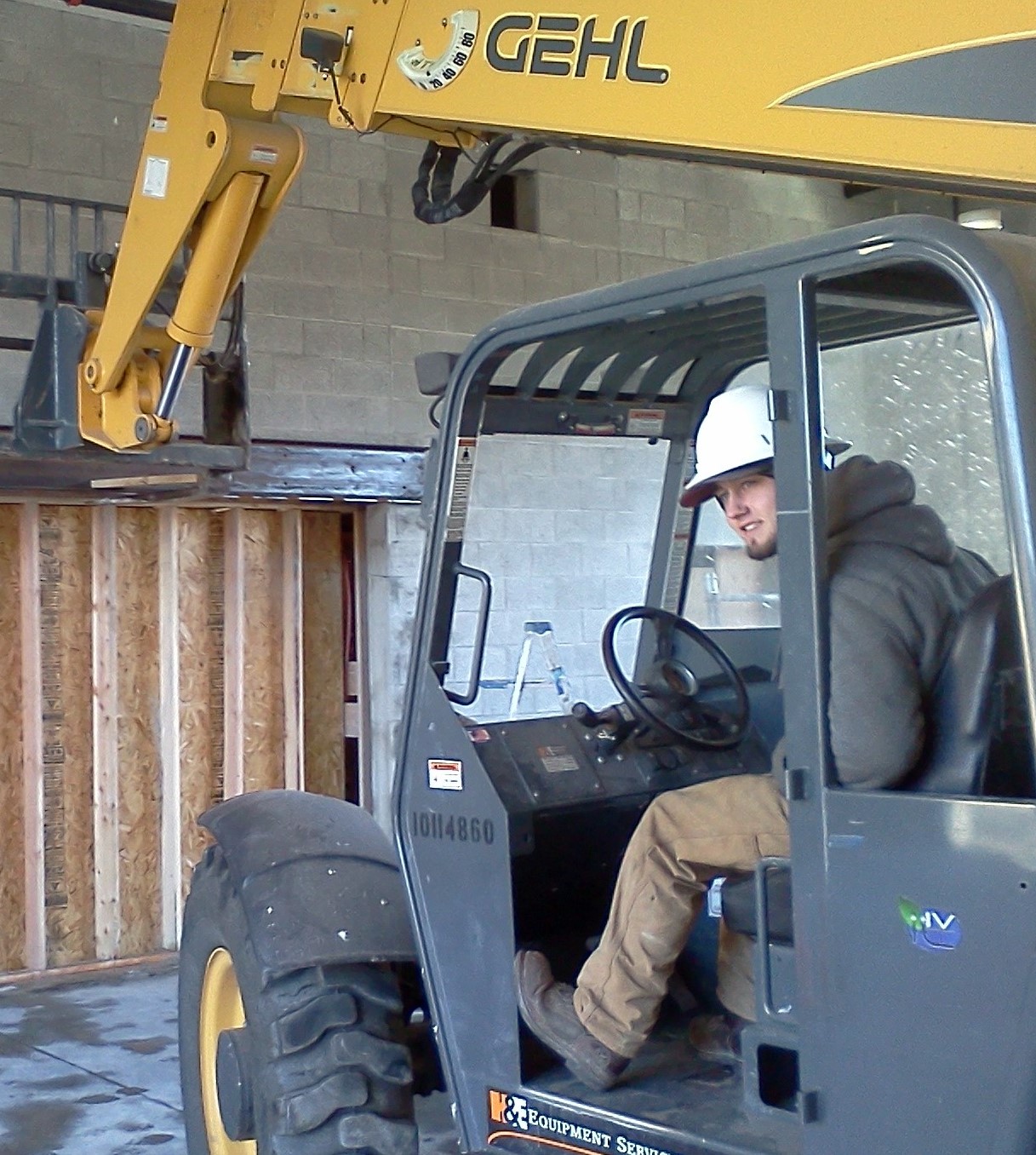 Gateway Builders superintendent Jacob Johnson in a man lift installing a steel beam at the entry for the new Heart of the city church building at Ramsey location Coeur d'Alene ID