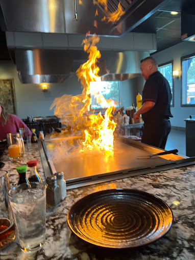 Hibachi table with flames and food cooking Just after Fuki Steak House was turned over by Gateway Builders for the grand opening at he Hayden ID location